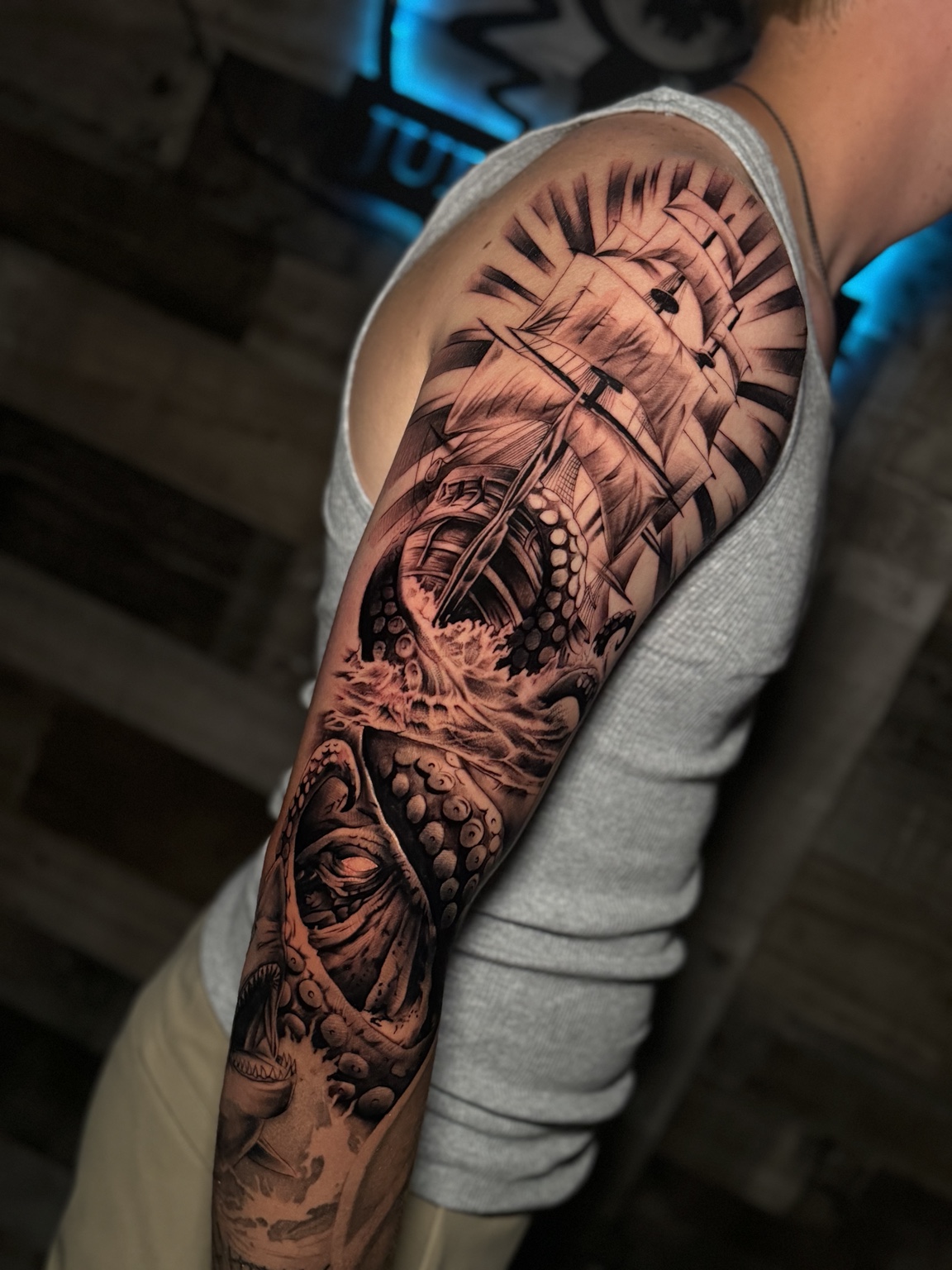 Large black and grey sleeve tattoo